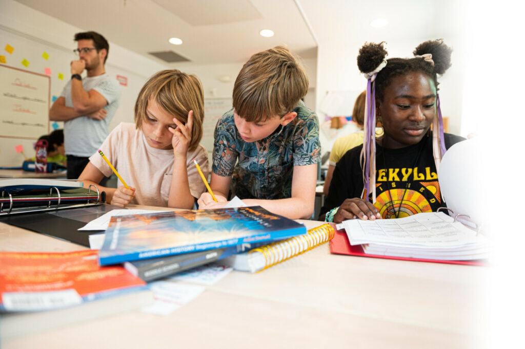 students at desk with books