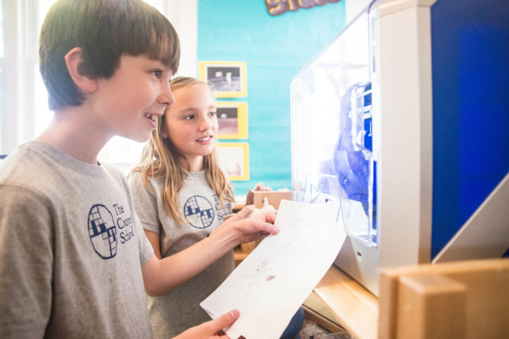 students in front of 3d printer