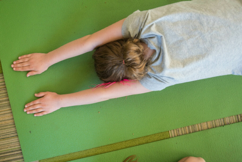 student on ground doing yoga