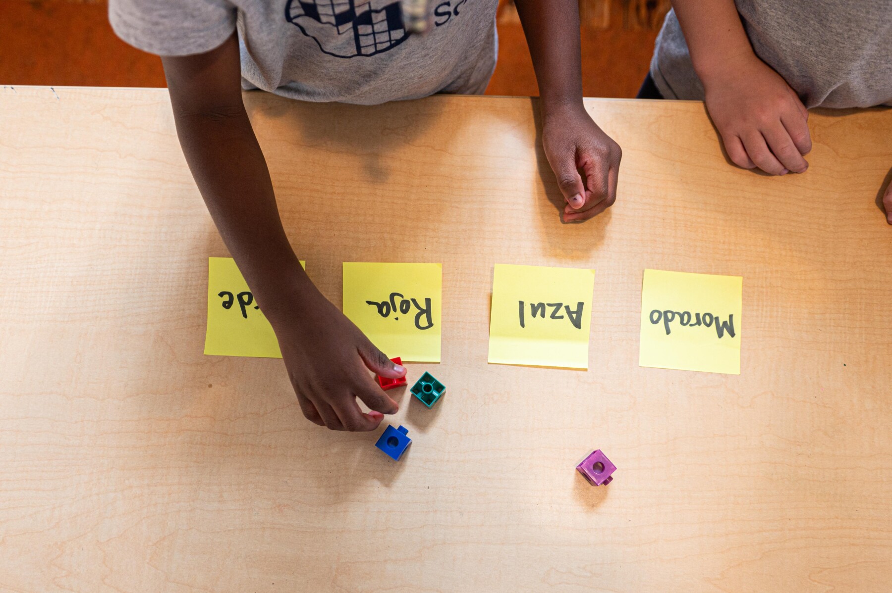 students at desk with sticky notes