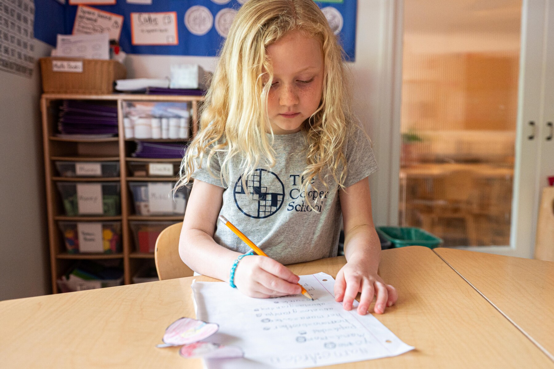 girl with artwork at desk