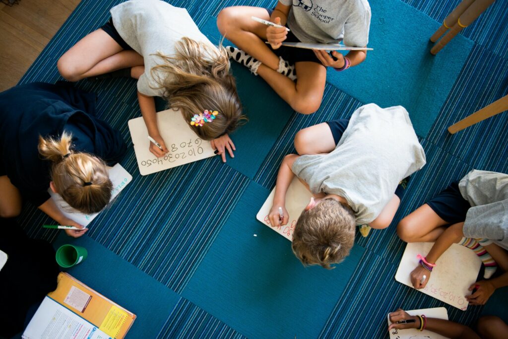 students in ground reading books