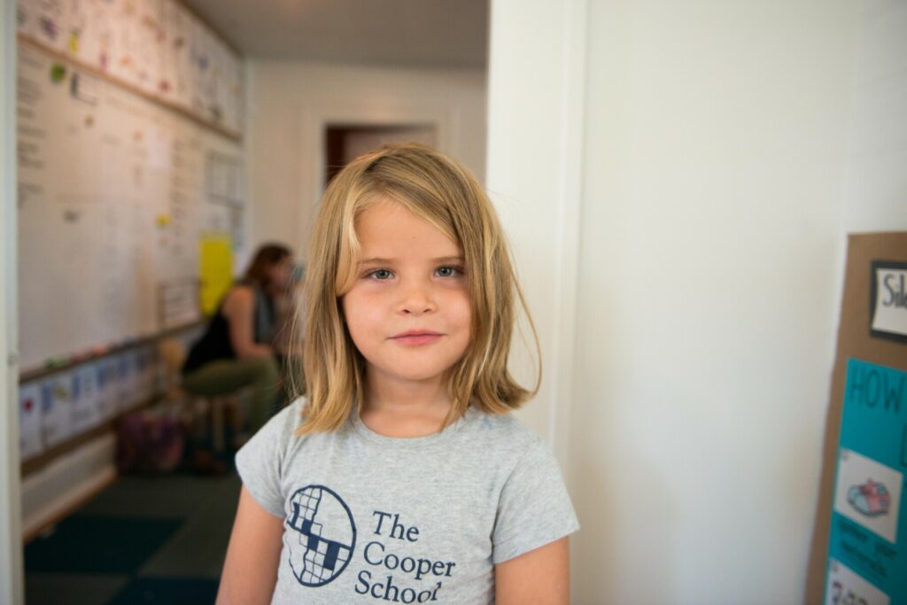 girl student standing in classroom