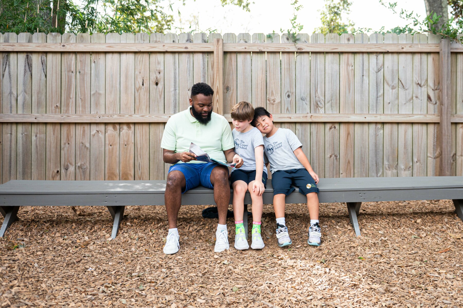 student and teacher sitting on bench