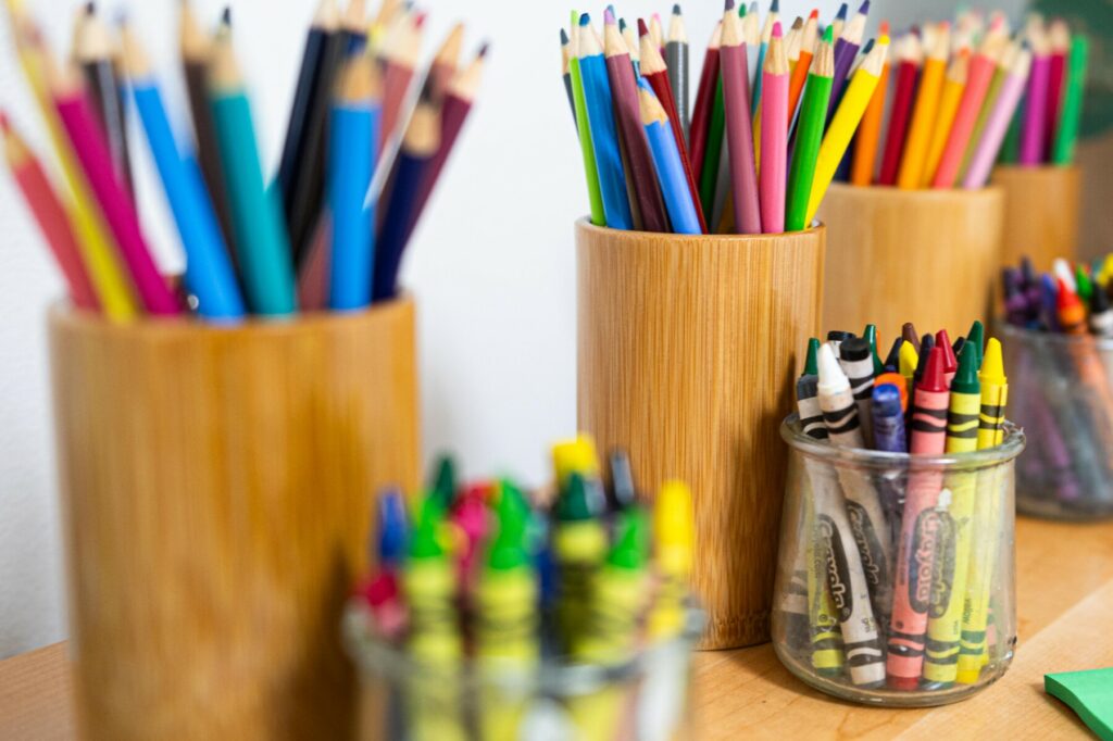 cups of colored pencils and crayons