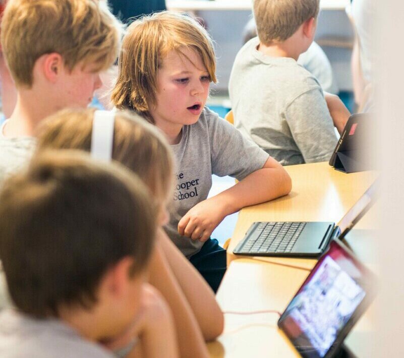 students at desk with technology 